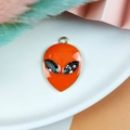3D alien head pendant with orange enamel and sparkling dark grey rhinestones in gold - Orange