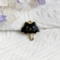 Close-up of black enamel cat umbrella pendant charm for DIY jewelry with gold metal edges - Black