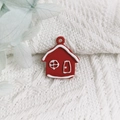 Macro shot of red holiday house alloy pendant with white snow detail for DIY jewelry - Red House Organizer