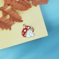 Macro detail of red enamel mushroom charms with cute smiling faces for DIY jewelry making - Red Smiling Mushroom