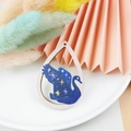 Detailed view of teardrop wood pendant featuring a blue starry sky swan design - Swan