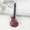 Macro detail of rock-style wooden guitar pendant with Let's Rock skull print - Skull Rock Style (LET'S ROCK)