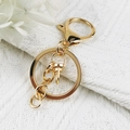 Detail view of gold-plated lobster clasp with chain and ring on white knit fabric - Large Lobster Clasp Flat Ring Chain Set / Gold