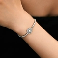 Close-up of elegant silver halo bracelet with sparkling cubic zirconia on female wrist - Round Halo Design Style (KB0543) / 18K Gold