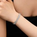Elegant silver tennis bracelet with baguette-cut cubic zirconia worn on a wrist - Baguette Cut Style (KB0539) / 18K Gold