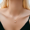 Detail of 18K gold plated necklace with minimalist ring and white pearl pendant on neck - Circle Pearl Necklace (KN0424)