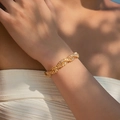 18K gold plated bracelet with sparkling twisted cubic zirconia on a female wrist - Gold Twisted Row Style (KB0780)