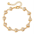Detail of 18K gold-plated bracelet with white heart-shaped links and lobster clasp - Opal Heart Bracelet (KB0799-1)