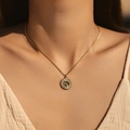 Vintage gold sunburst necklace with blue turquoise evil eye pendant on a female model - Sun God Turquoise Style (SN0012)
