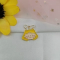 Macro view of cute cartoon girl charm with yellow hair and enamel drip for DIY jewelry - Rabbit Ear Princess Head
