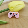 Detailed view of pink resin mini game controller charm with colorful buttons and tulip decor - Pink