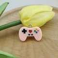 Detail of pink resin game controller charm with heart button for DIY jewelry making - Champagne
