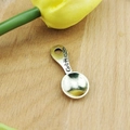 Macro view of spoon-shaped metal pendant with Get through engraving and hanging hole - Spoon / Antique Silver