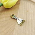 Detail view of antique gold cutlery fork pendant with Get through engraving for DIY jewelry - Fork / Antique Gold