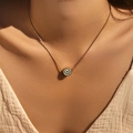 Golden snake chain necklace with green enamel evil eye pendant worn by a model - Green Base Evil Eye Style (SN0020-2)