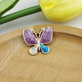 Detail shot of a butterfly charm with purple glitter wings and crystals on wood - Purple Blue Butterfly