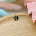 Close-up of black enamel cherry blossom pendant charm for DIY jewelry making - Black