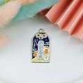 Detailed shot of an enamel lucky charm pendant with a white cat and floral motifs - Peace and Joy
