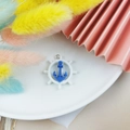 DIY nautical resin charm featuring a white ship wheel and navy anchor with metal ring - Ship Wheel