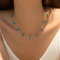 Golden necklace with dark blue round beads and gold spacers on model neck - 18K Gold / Blue Style (KN0609-4)