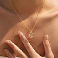 Golden necklace with emerald shell pendant and gold floral motif on a fine chain - Oval Botanical Floral Style (KN0602-4)