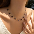 Elegant gold necklace featuring faceted deep purple beads worn by a model in nature - 18K Gold / Purple Style (KN0609-8)