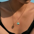 Macro detail of Bohemian golden shell pendant with vibrant iridescent blue inlay - Round Rainbow Ocean Style (KN0601-5)