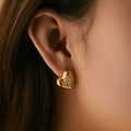 Minimalist 18K gold plated heart stud earrings with cubic zirconia shown on ear - Heart Shape Style (KE1683)