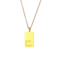 Macro view of gold square pendant engraved with made of magic on a dainty link chain - Made of Magic