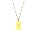 Macro view of gold square pendant engraved with stay soft on a minimalist chain - Stay soft