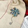 Macro shot of colorful enamel firework brooch with dangling snowflake tassel detail - Multicolor Tassel Firework Silver