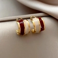 Retro irregular striped enamel hoop earrings in gold and burgundy on champagne satin fabric - Red