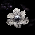 Elegant silver rose brooch with black pearl and crystal pave setting on black background - Silver-Grey Pearl Rose