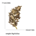 Golden leaf brooch with sparkling champagne rhinestones in 7.1cm x 4.2cm size - Brown