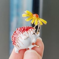 Enamel hedgehog brooch pin holding a yellow daisy with polished gold plating - Yellow Flower