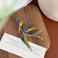 Detail of blue swallow brooch featuring pave-set crystals on silver alloy base - Yellow