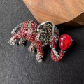 Macro detail of elephant brooch featuring a large red teardrop rhinestone and silver alloy - Red