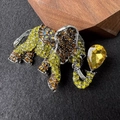Macro view of elephant brooch with vibrant green and yellow pavé crystal inlay - Yellow