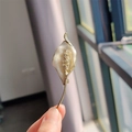 Macro detail of calla lily brooch with white enamel petals and crystal encrusted stamen - Gold