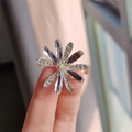 Macro shot of a daisy brooch with purple gemstones and sparkling zircon petals - Daisy Style / Purple and Gold Daisy (XZ0266-1)