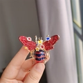Detailed close-up of a vintage bee brooch with red rhinestones and colorful enamel wings - Red Flower Style (XZ0271-1)