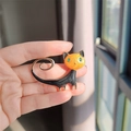 Cat brooch with orange head and black enamel body featuring green gemstone eyes and gold trim - Black and Orange Cat
