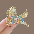 Exquisite golden flying horse brooch with colorful crystals held in hand showcase - Hollow Colorful Crystal Horse Gold