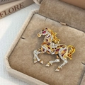 Macro detail of a running horse brooch with crystals in a velvet jewelry box - Brown