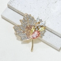 Golden maple leaf brooch featuring pink and yellow rhinestones on textured white marble - Maple Leaf Style (KC Gold Maple Orange Brooch) / Gold/Orange