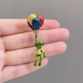 Detail of a cute enamel frog balloon brooch with vibrant colors and high-gloss finish - Frog with Balloons / Green Multi-color