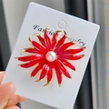 Close-up of red enamel sunflower brooch with white pearl center on a fashion jewelry card - Red Sunflower Brooch