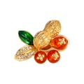 Elegant peanut brooch with gold metal, green enamel leaf, and orange berry accents - Good Things Happen