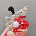 Macro shot of a Chinese dragon brooch with red enamel, gold plating and pearl detail - Gold Black
