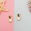 Detailed view of enamel stationery cup charms with pens and flowers for DIY jewelry - White
